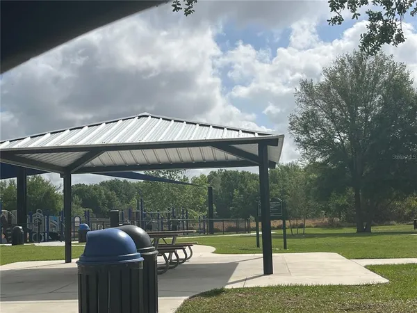a patio with a yard and furniture
