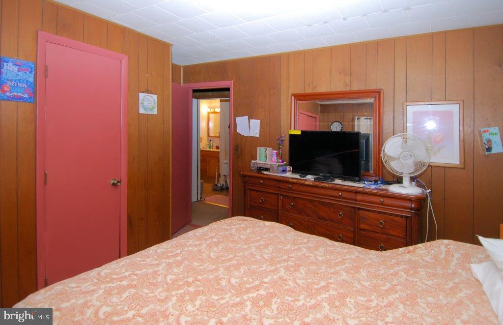 565 Nottingham Road Elkton, MD 21921 - Photo 14 of 51 a bedroom with a bed and a flat screen tv
