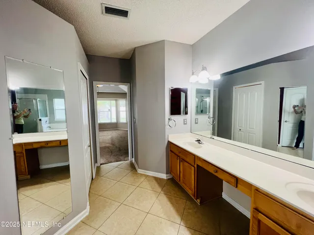 a spacious bathroom with a sink a mirror and a bathtub