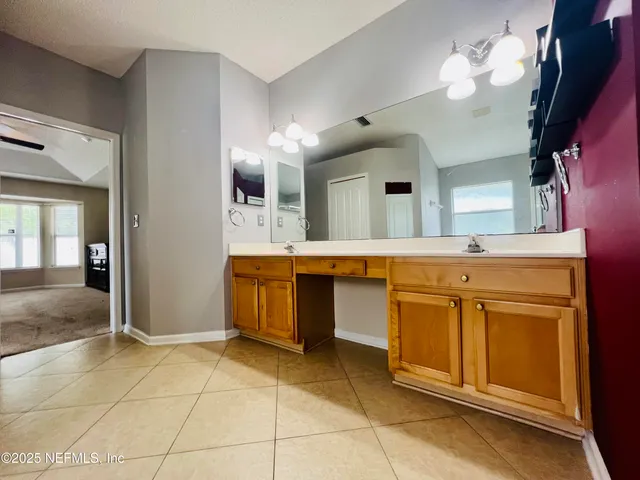 a spacious bathroom with a sink vanity and a mirror