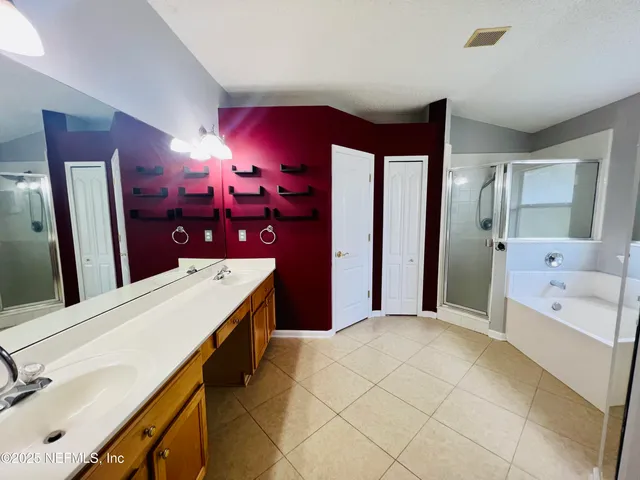 a spacious bathroom with a bathtub and a shower