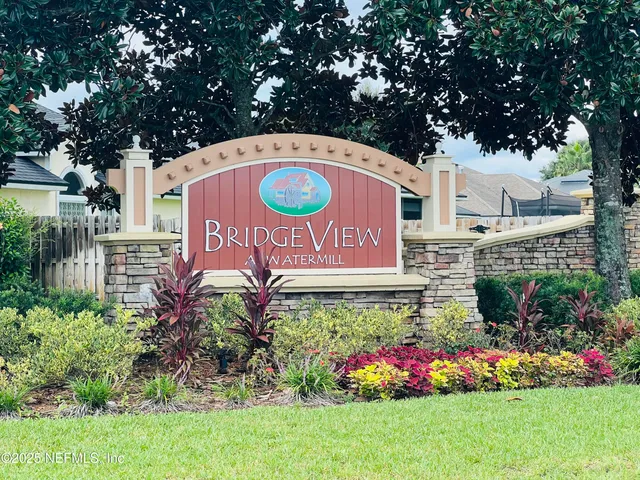 a living room with a fireplace and a ceiling fan