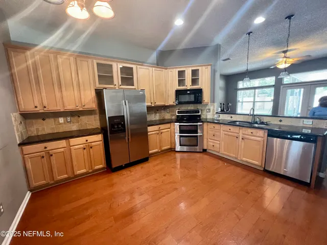 a view of workspace with furniture and a ceiling fan