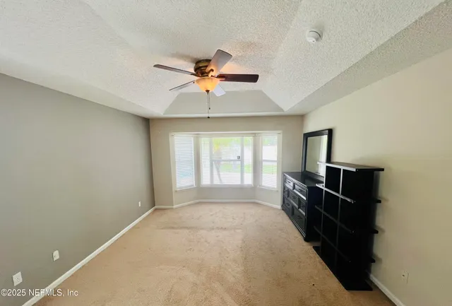 a spacious en suite bathroom with a double vanity sink and mirror