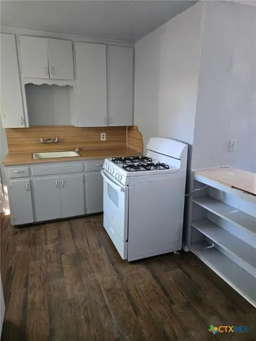 a kitchen with a stove and a microwave