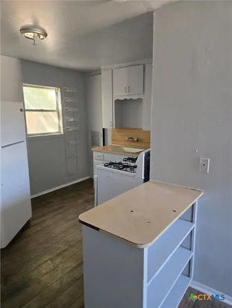 a kitchen with a stove a sink and a refrigerator