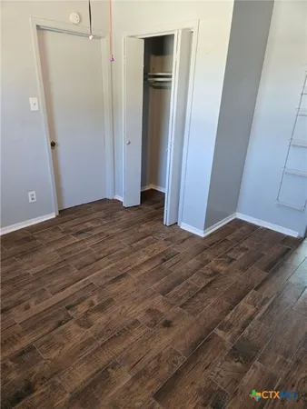 a view of room with wooden floor