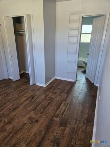 a view of hallway with wooden floor