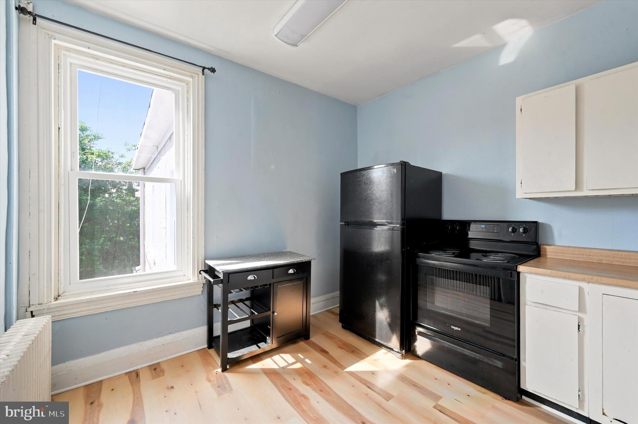 204 Ripka Street, Unit 2 Philadelphia, PA 19127 - Photo 8 of 22 a kitchen with a refrigerator stove and wooden cabinets