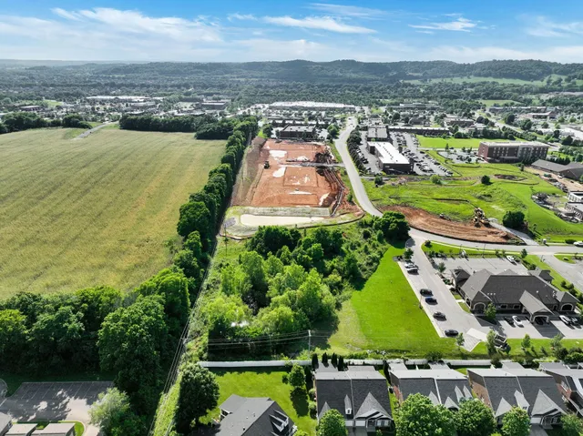 an aerial view of residential houses with outdoor space and river