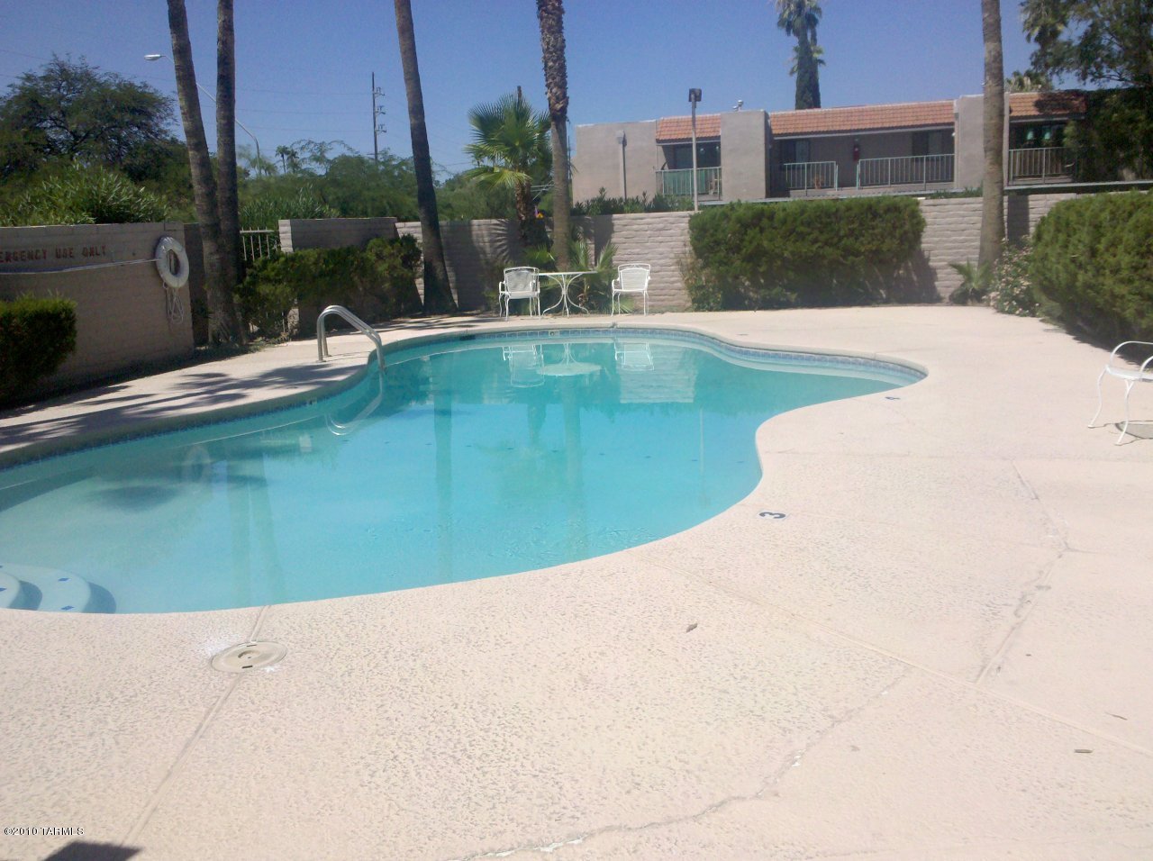 6615 East Golf Links Road, Unit 9 Tucson, AZ 85730 - Photo 5 of 6 a view of a swimming pool with a yard