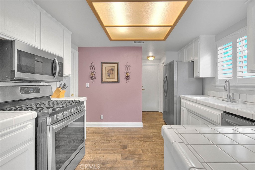 14452 Harvey Lane Riverside, CA 92503 - Photo 11 of 50 a kitchen with stainless steel appliances granite countertop a sink stove and refrigerator