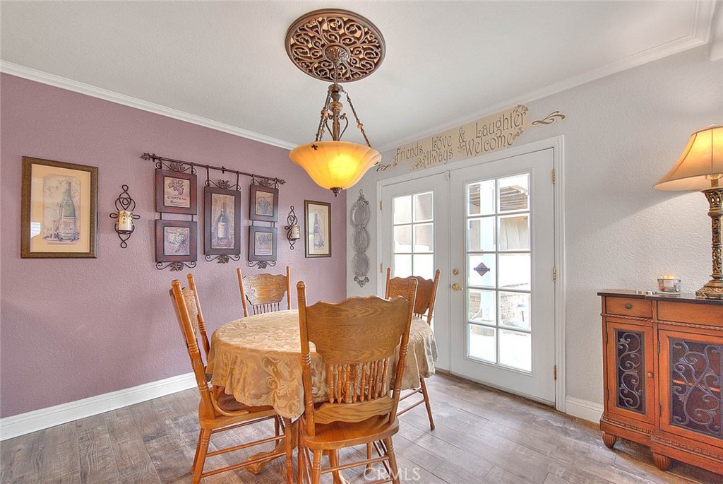 14452 Harvey Lane Riverside, CA 92503 - Photo 16 of 50 a view of a dining room with furniture wooden floor and chandelier