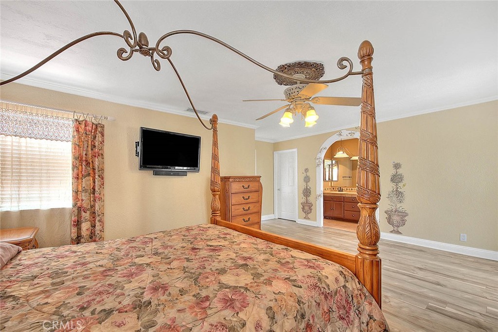 14452 Harvey Lane Riverside, CA 92503 - Photo 22 of 50 a bedroom with a bed and a flat screen tv