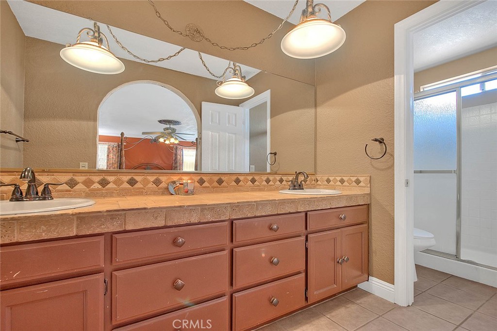 14452 Harvey Lane Riverside, CA 92503 - Photo 27 of 50 a bathroom with a double vanity sink and a mirror
