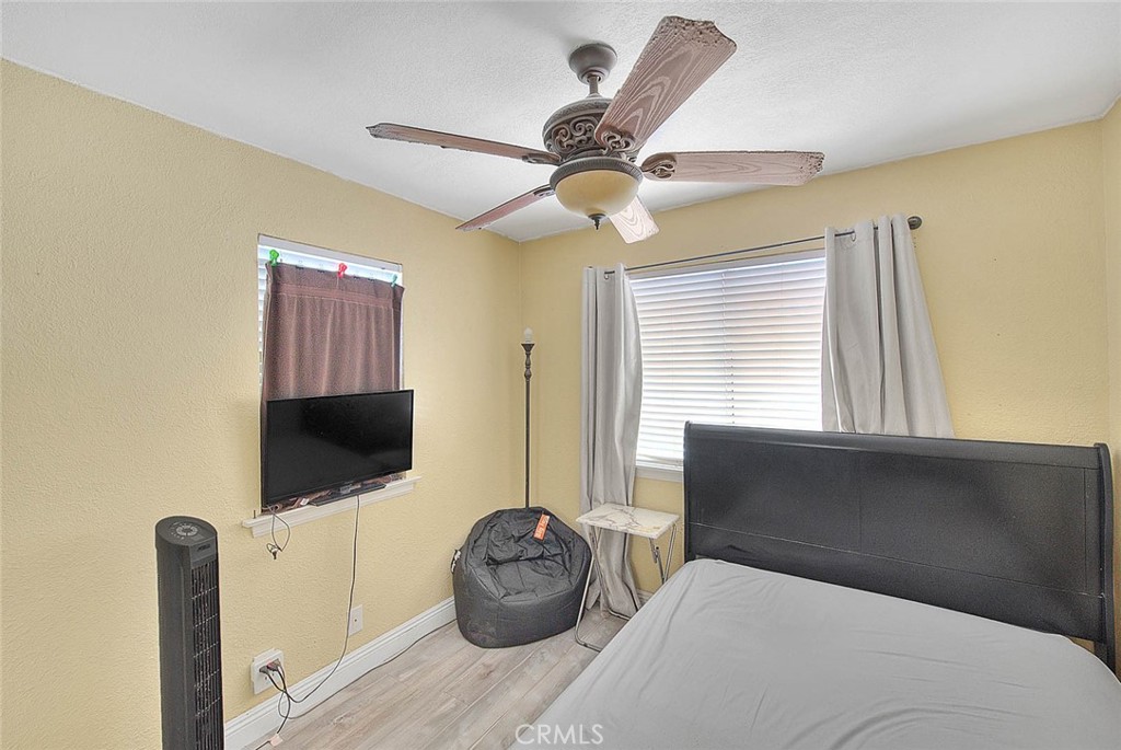 14452 Harvey Lane Riverside, CA 92503 - Photo 29 of 50 a bedroom with a bed and a flat screen tv