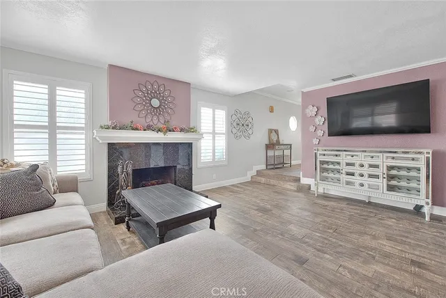 a kitchen with kitchen island a stove a sink and white cabinets