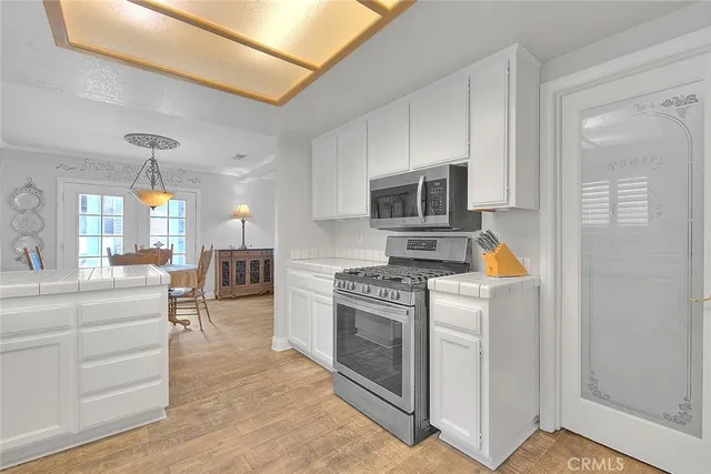 a view of a dining room with furniture and chandelier