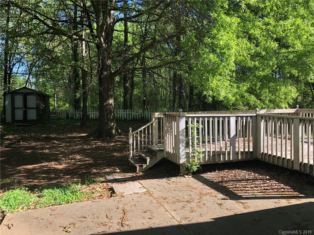 6319 Nevin Road Charlotte, NC 28262 - Photo 5 of 7 a view of a wooden bench on the side of a road