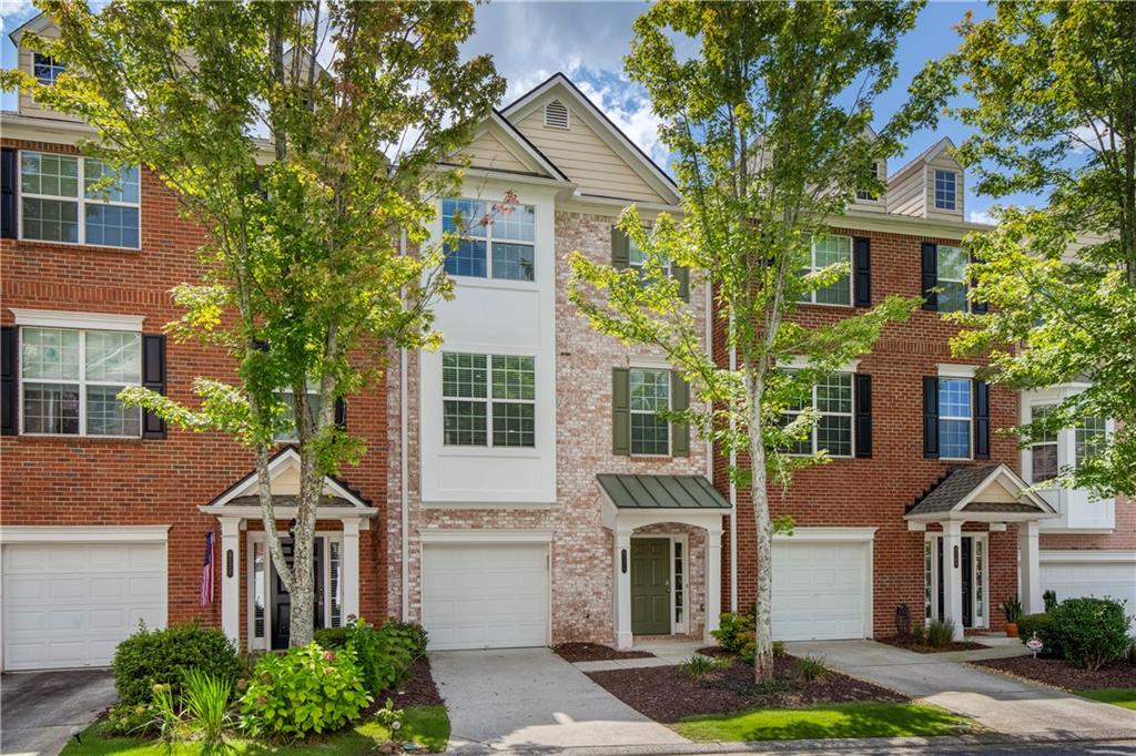 5171 Wellsley Bend Alpharetta, GA 30005 - Photo 1 of 1 a front view of a house with a yard and garage