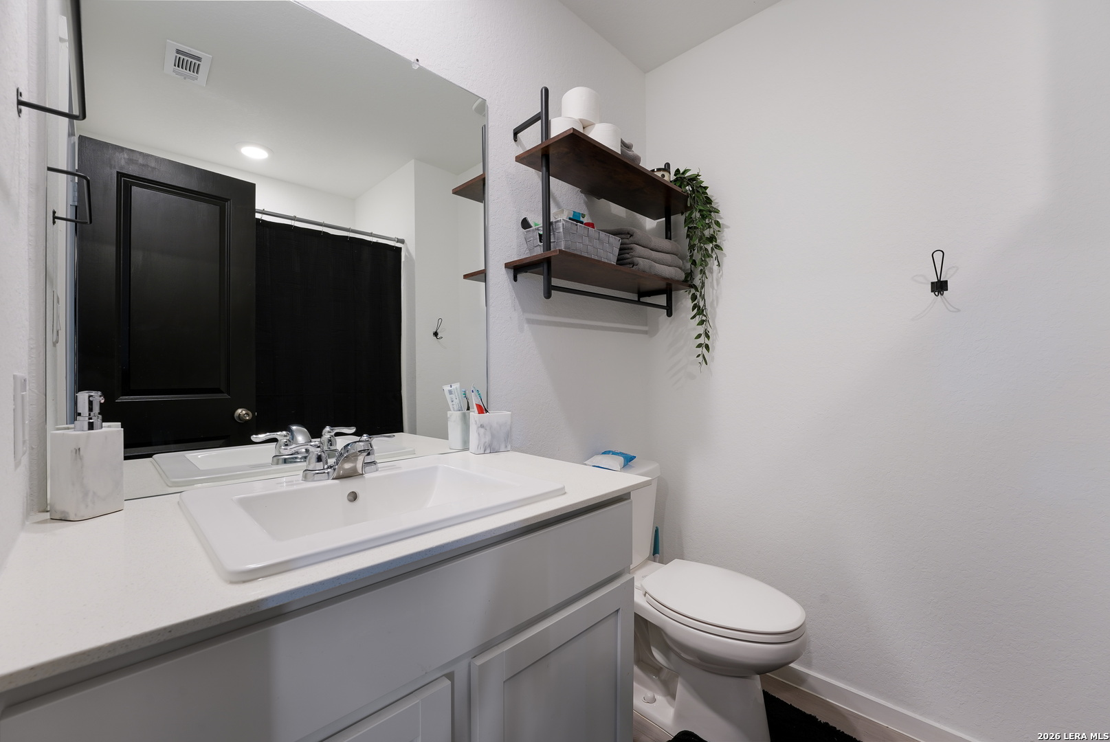 13012 Hancock Pool St. Hedwig, TX 78152 - Photo 22 of 32 a bathroom with a sink toilet and mirror