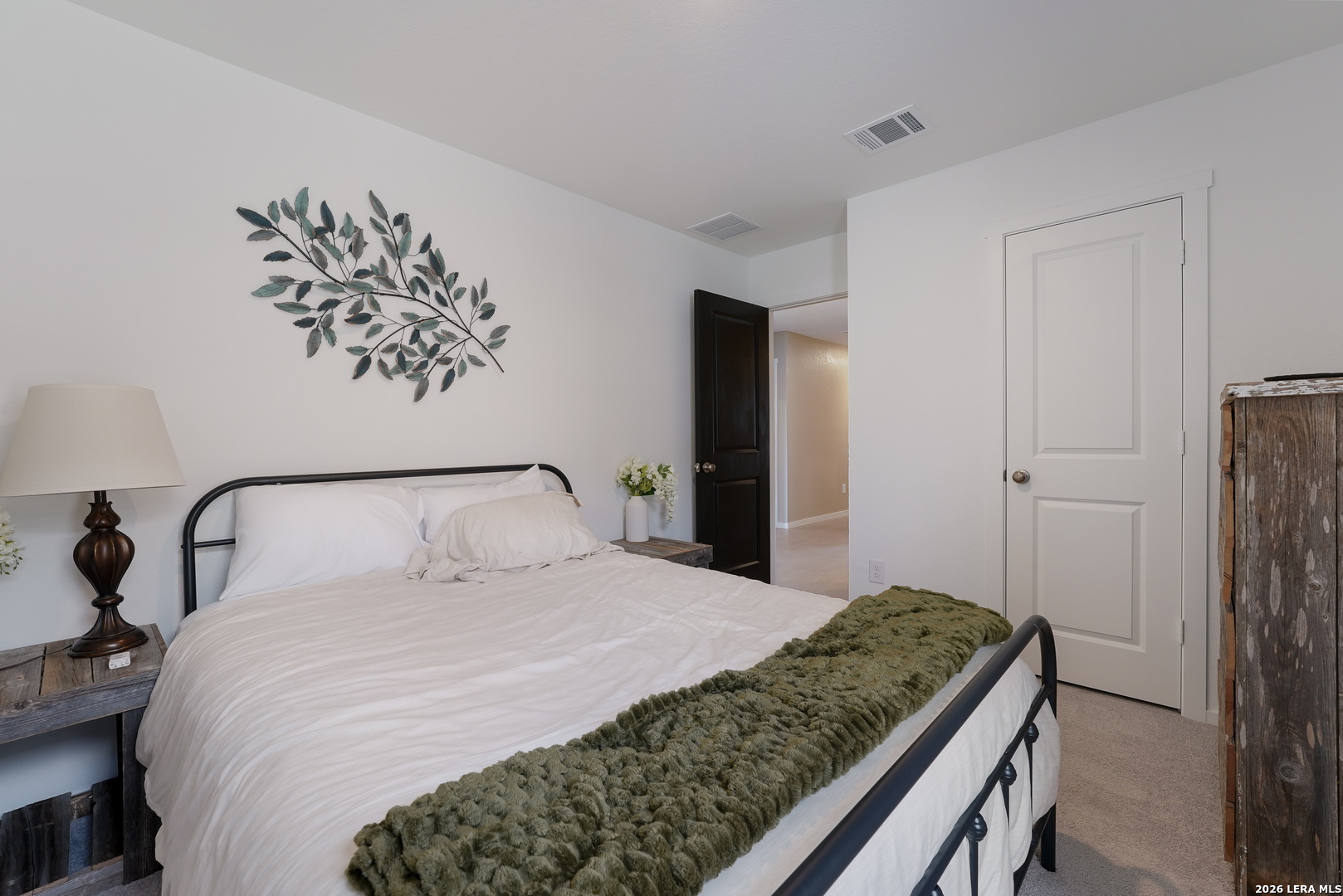 13012 Hancock Pool St. Hedwig, TX 78152 - Photo 24 of 32 a bedroom with a large bed and a chandelier