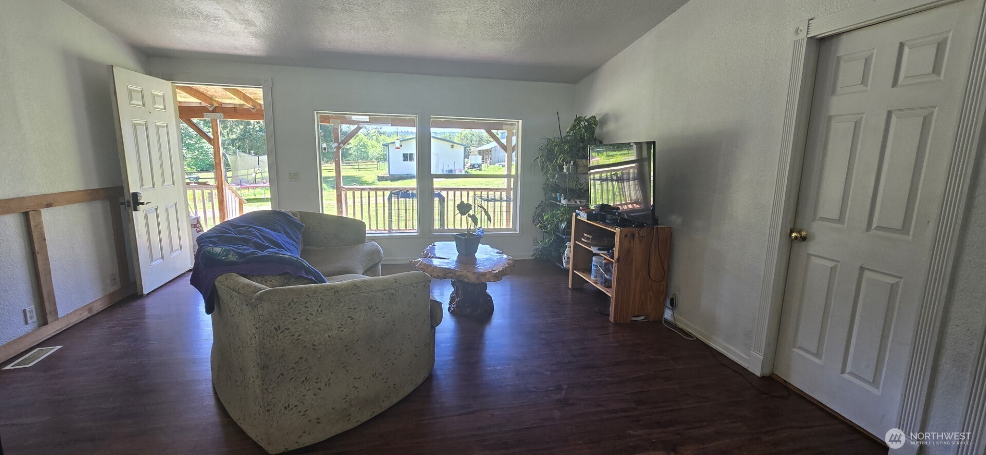 123 Barton Road Rochester, WA 98579 - Photo 16 of 25 a living room with furniture and a large window