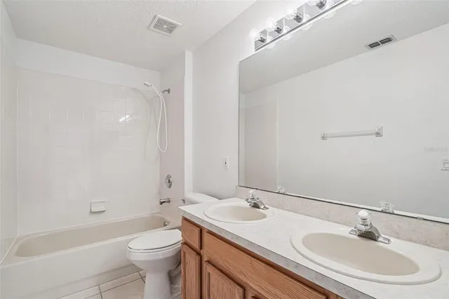 a bathroom with a sink toilet tub and shower