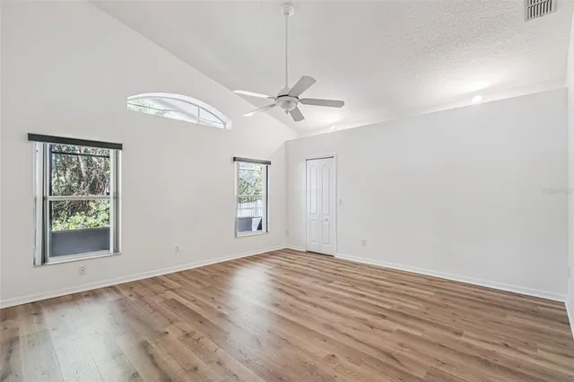 wooden floor in an empty room with a window