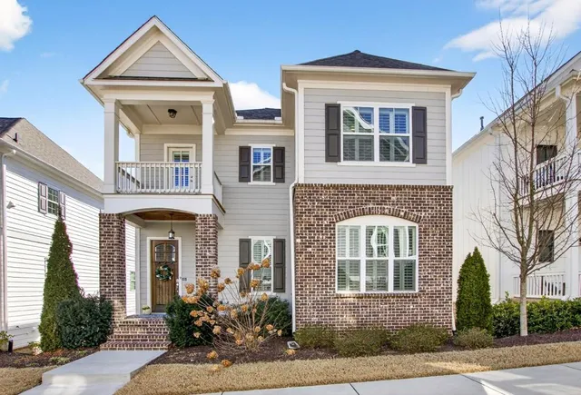 front view of a brick house with a small yard