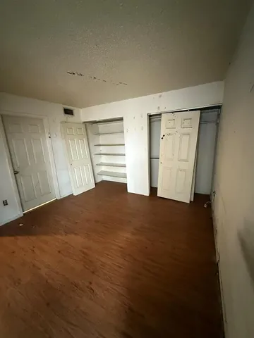 a bathroom with a white toilet sitting bathtub and shower
