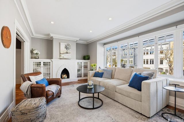 a living room with furniture a rug and a fireplace