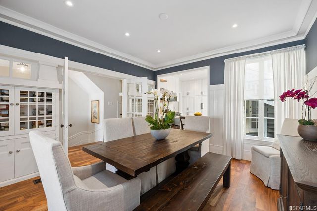 a living room with furniture a table and wooden floor