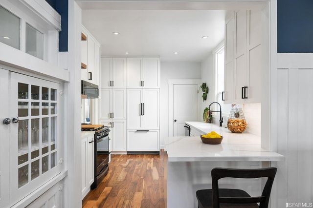 a view of a workspace with furniture and wooden floor