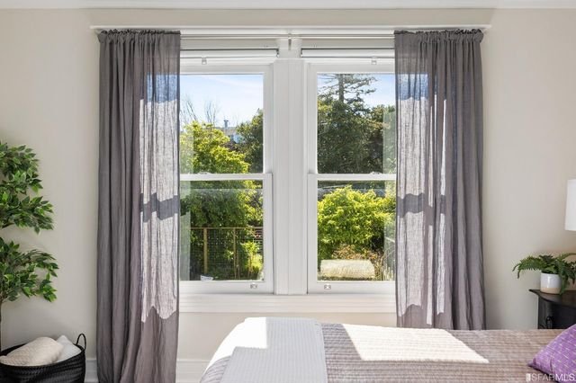 a view of a door and chair in front of a window