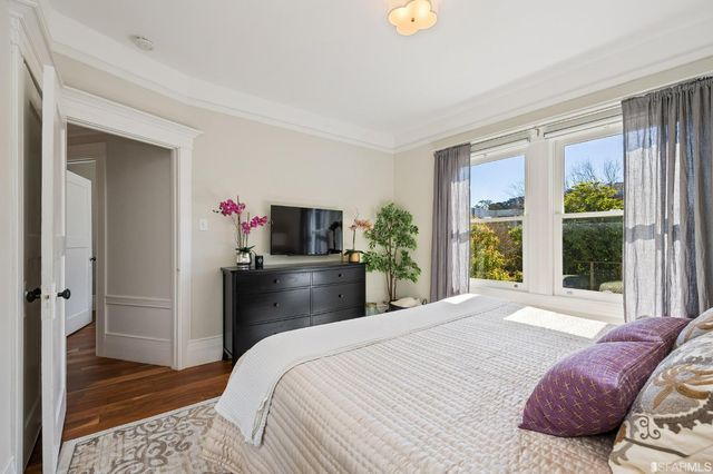 a bedroom with a bed and a large window