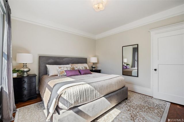 a bedroom with a bed and a mirror