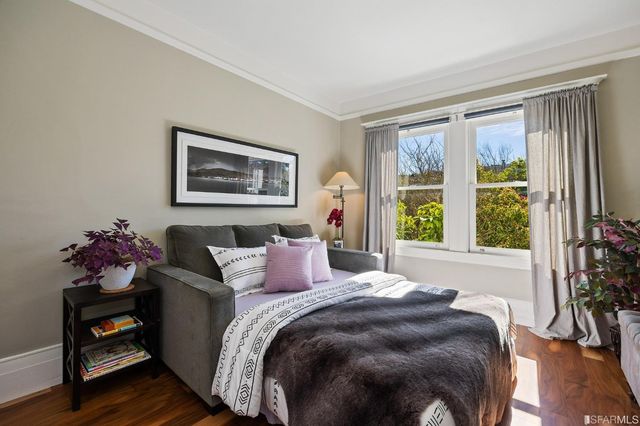 a bedroom with a bed and a large window
