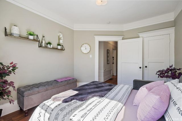 a bedroom with a bed and a potted plant