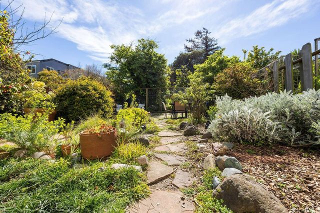 a view of a patio with table and chairs and potted plants