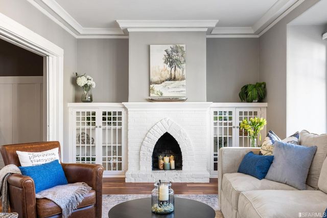 a living room with furniture fireplace and window