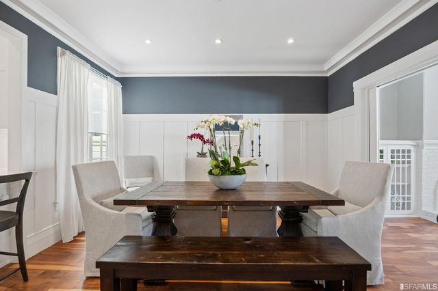 a view of a dining room with furniture and wooden floor