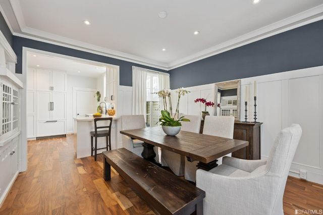 a view of a dining room with furniture and wooden floor