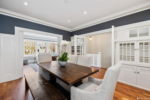 a view of a dining room with furniture and wooden floor