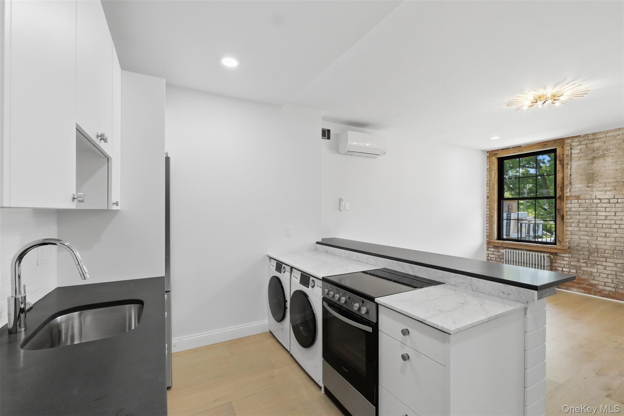 207 Main Street, Unit 5 Beacon, NY 12508 - Photo 5 of 20 a utility room with dryer and washer