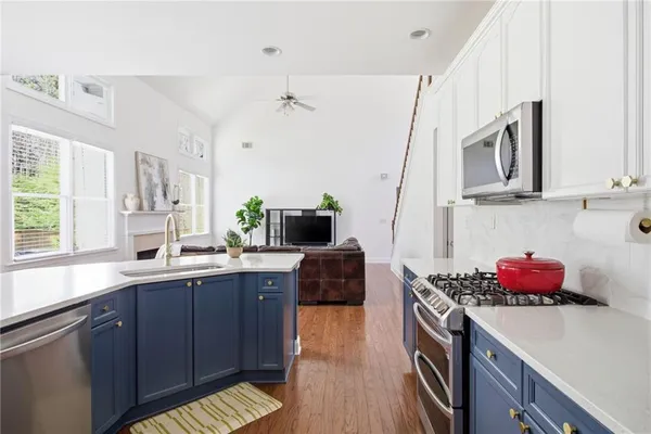 a kitchen with stainless steel appliances granite countertop a sink and cabinets