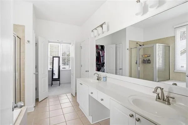 a spacious bathroom with a double vanity sink mirror and double
