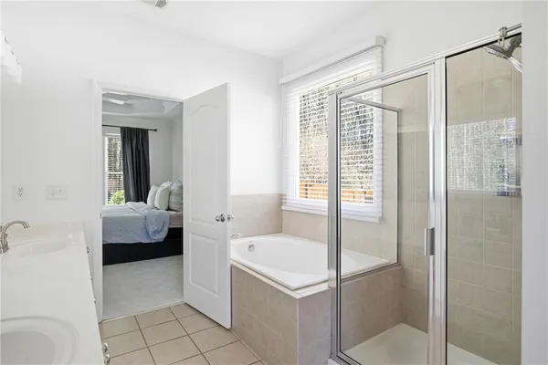 a en suite bathroom with a tub shower and sink