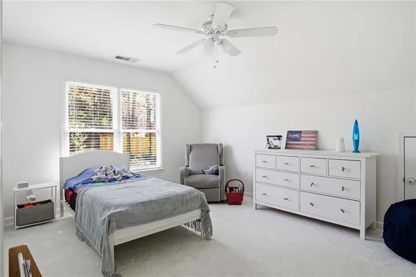 a bedroom with a bed and a dresser