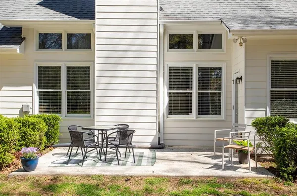 a view of a house with a yard and sitting area